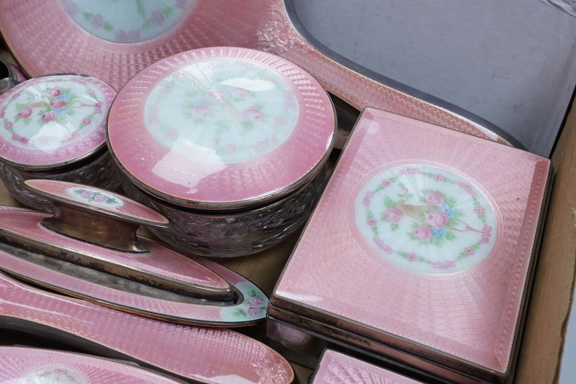 An early century North American sterling and enamel dressing table set by Theodore W. Foster & Bro, comprising fourteen items including hand mirror, 29.1cm, brushes, trinket box, nail buffer on stand, toilet jars, powder